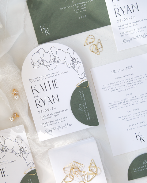 Blossie Arch wedding invitation that has letterpress and orchid illustration. Seedling green RSVP and envelope